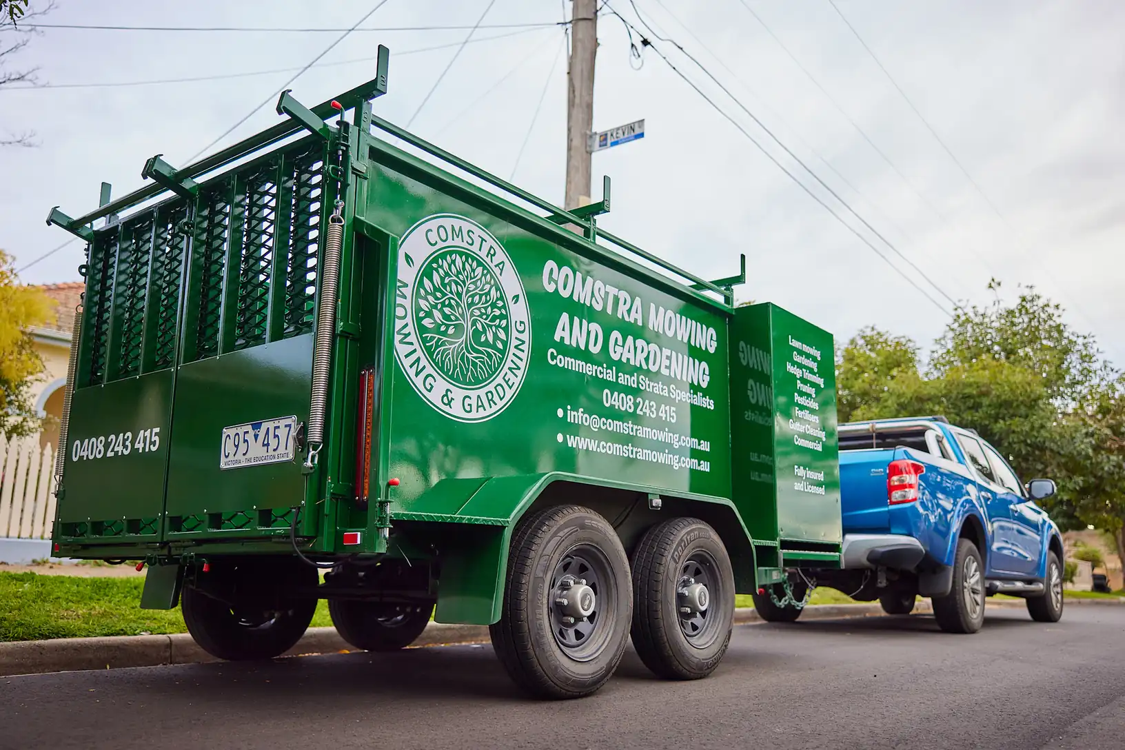 COMSTRA Mowing branded ute and trailer parked on a residential street in Derrimut, Melbourne's west