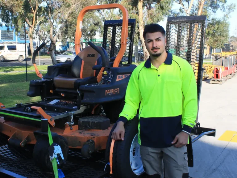 COMSTRA Mowing gardener with a zero-turn mower loaded for transport to an industrial site