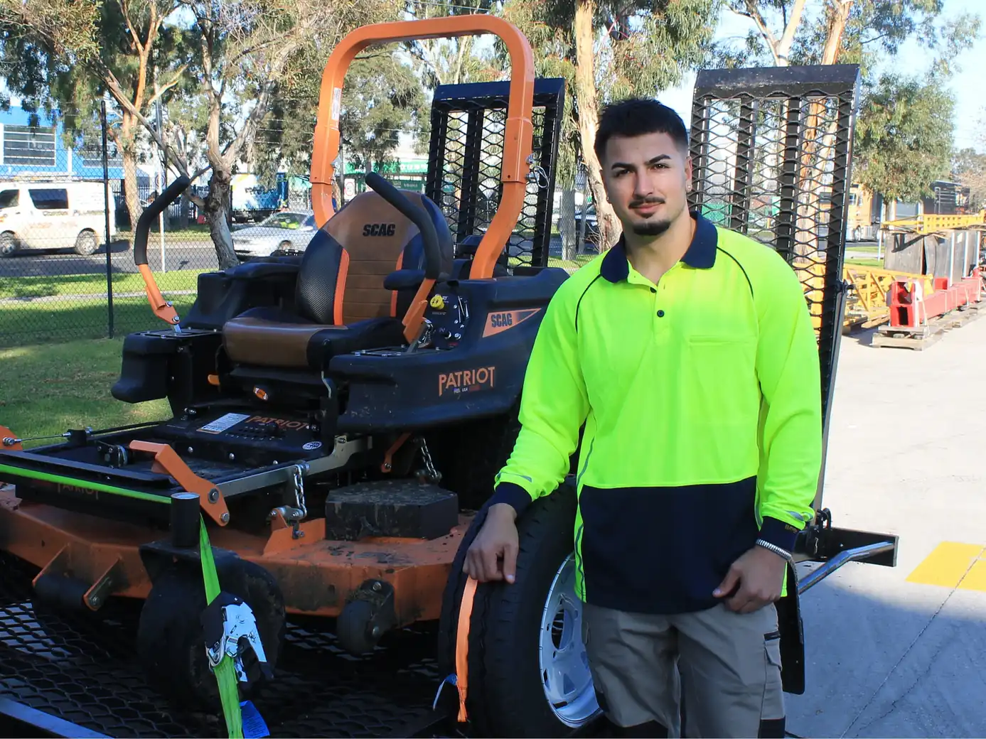 COMSTRA Mowing gardener with a zero-turn mower loaded for transport to an industrial site