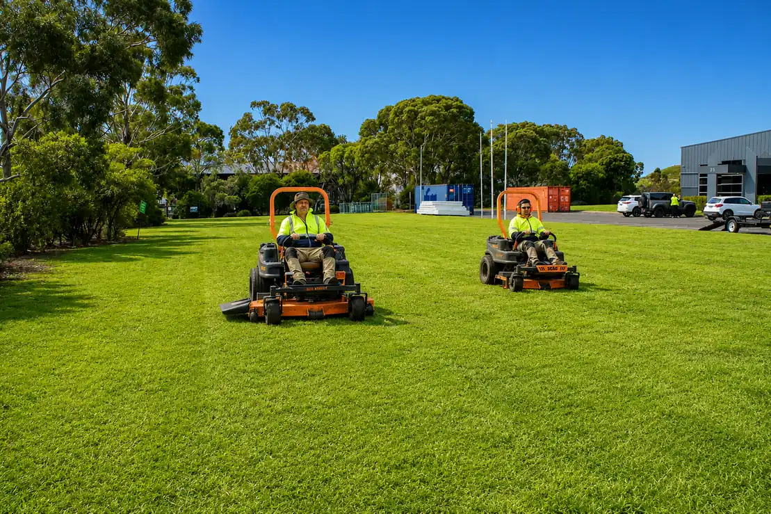COMSTRA Mowing gardeners ride-on mowing a large industrial estate lawn in Corio